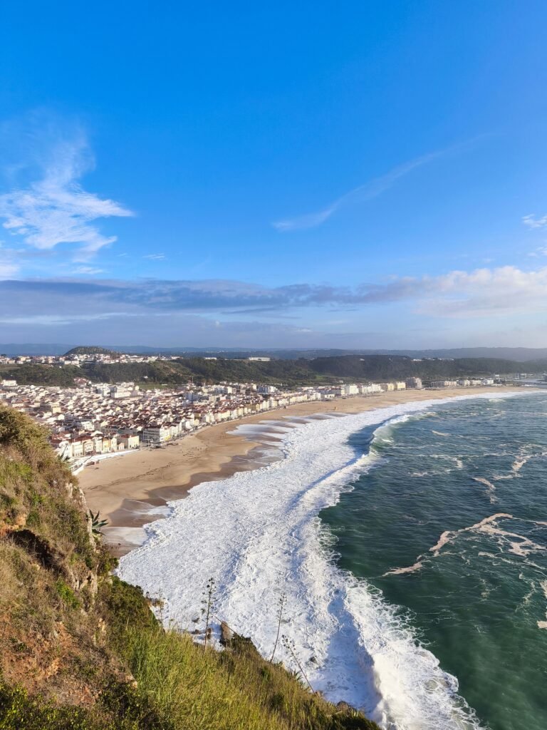 Nazar&eacute; seen from the clifftop above the town, with its long sandy beach and white Atlantic surf