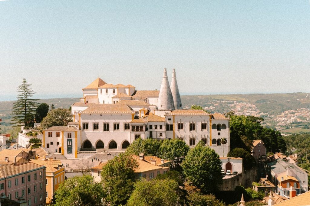 The Sintra National Palace and its two white conical chimneys above the historic centre of Sintra